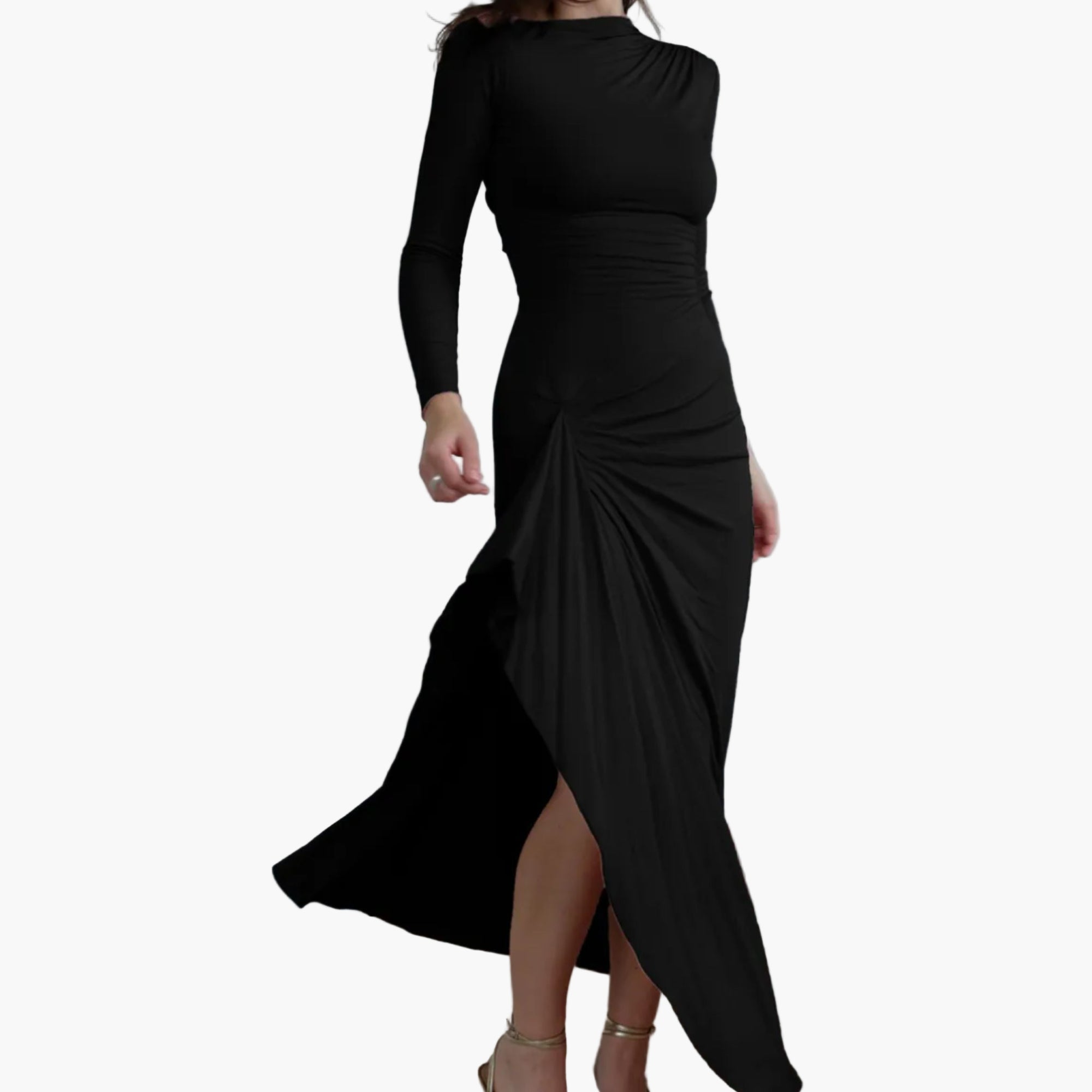 Black dress with a high slit worn by a person, standing against a white curtain.