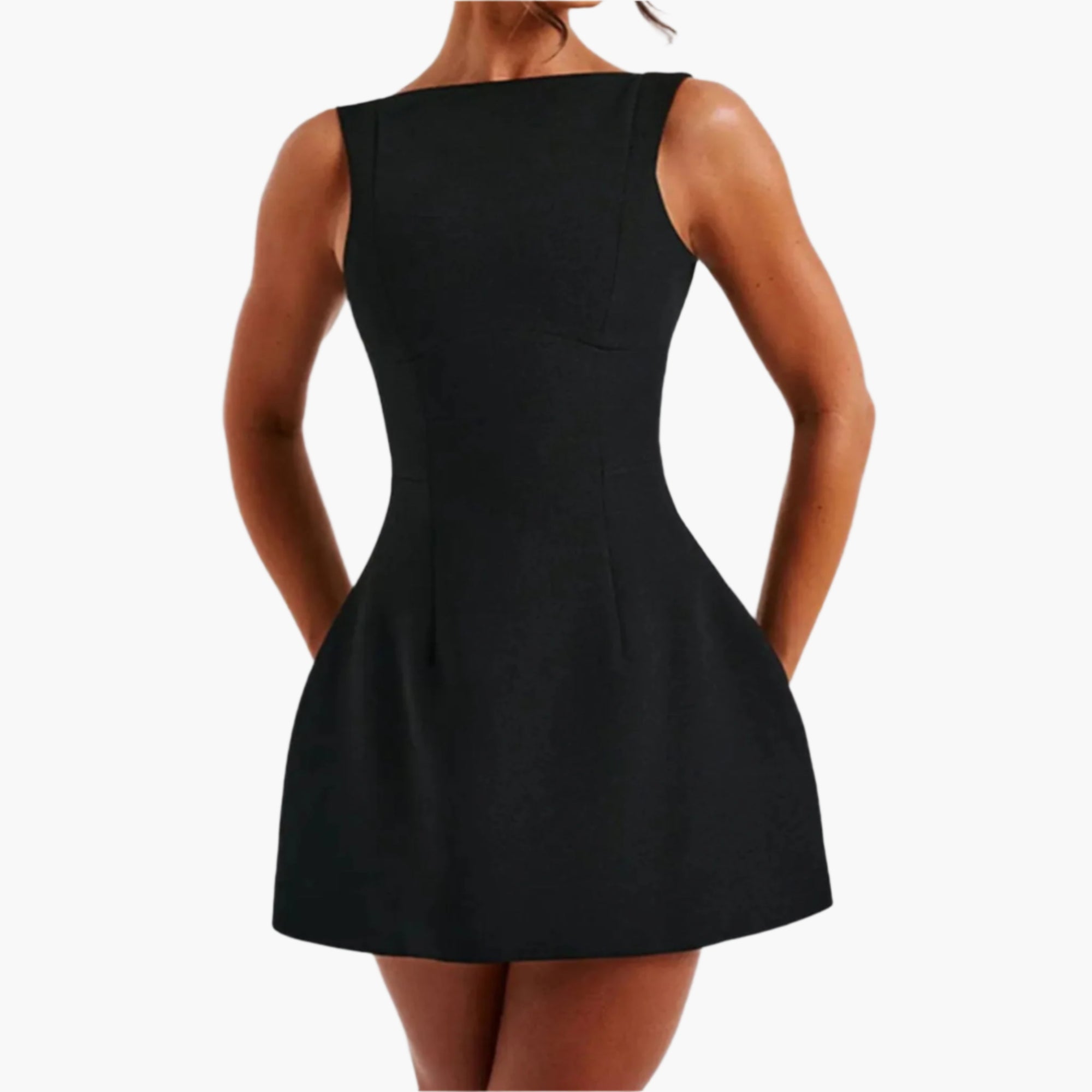 Model wearing a  Black mini-length sleeveless dress with round neckline and fitted silhouette.