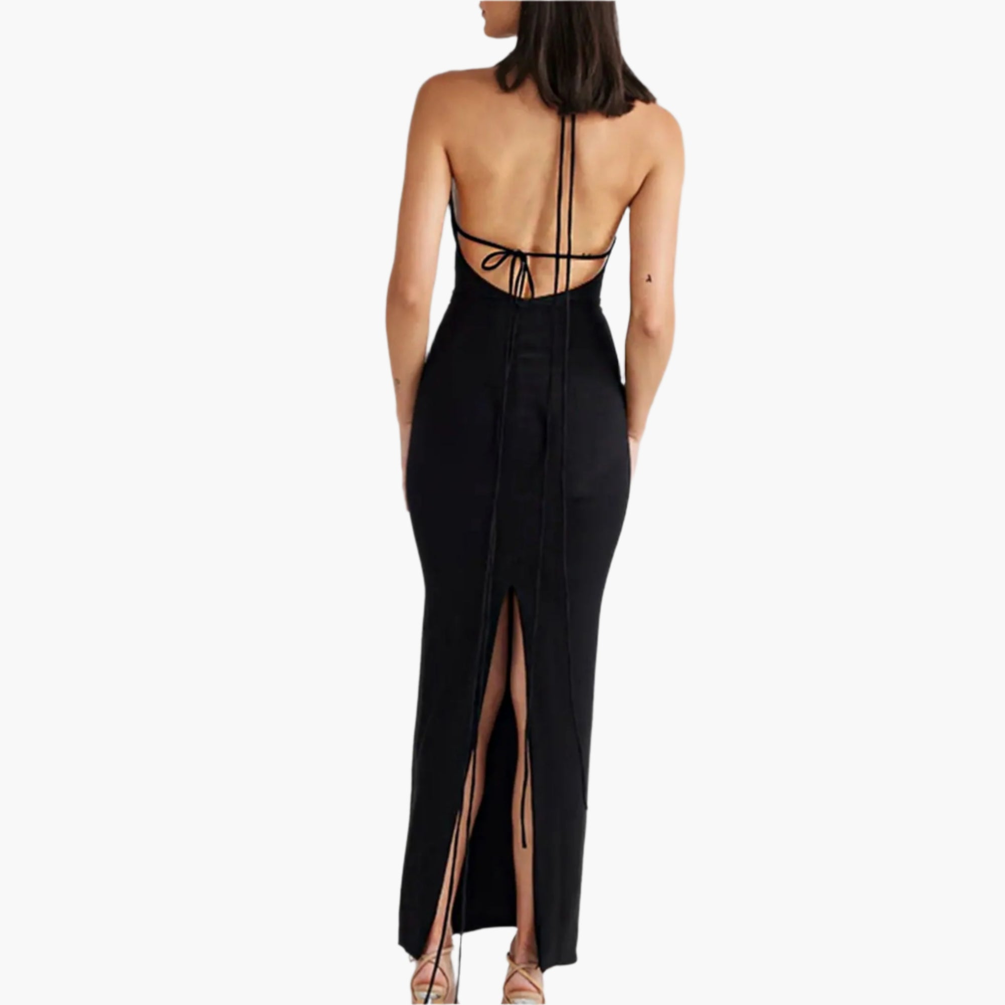 Black open-back dress with a high slit on a white background