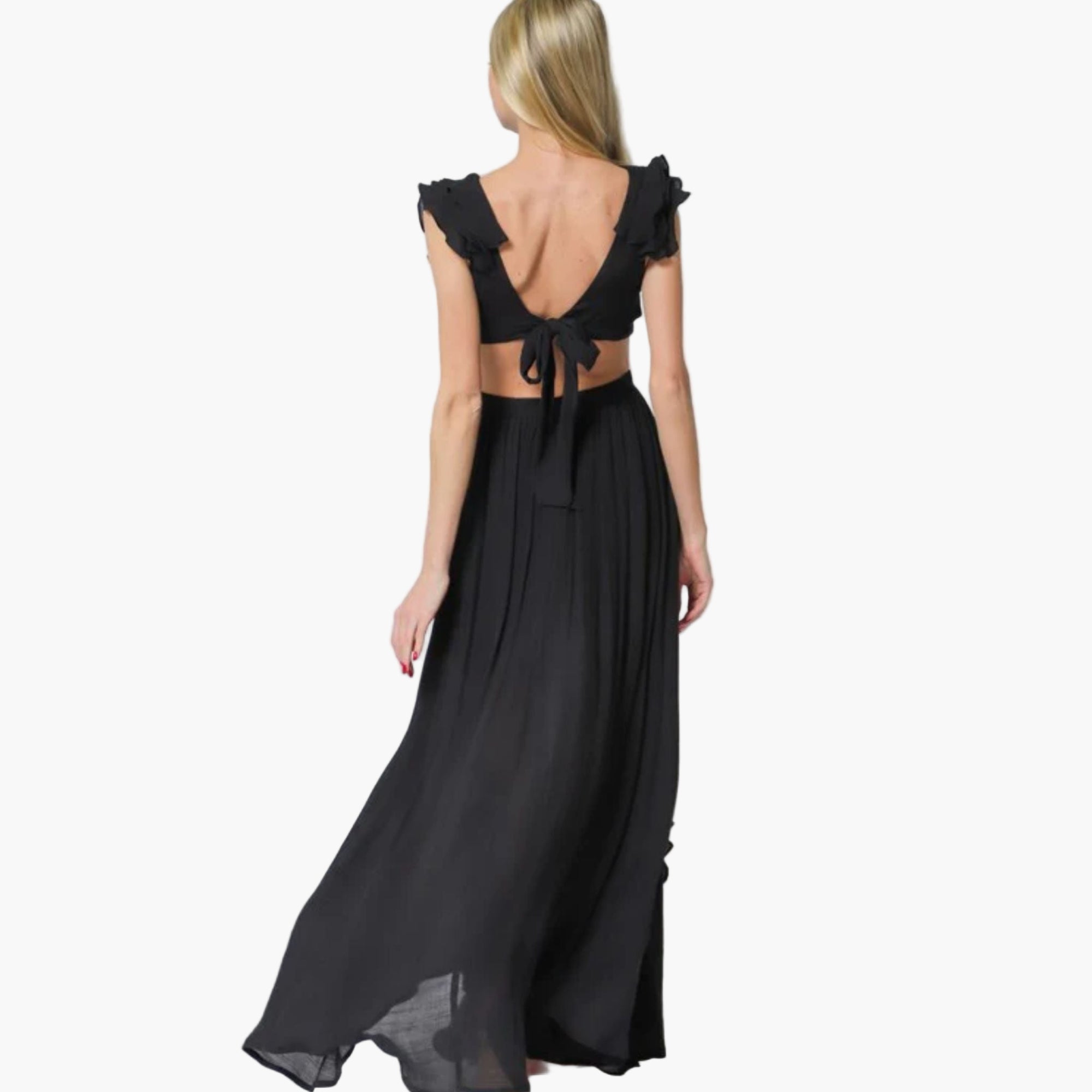 Back view of ruffled cap sleeve dress with side cutouts and leg slit